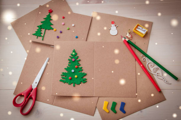istock Signing Handmade Christmas cards. Felt, scissors, buttons, Christmas-tree, scrapping. Flat lay 879304808