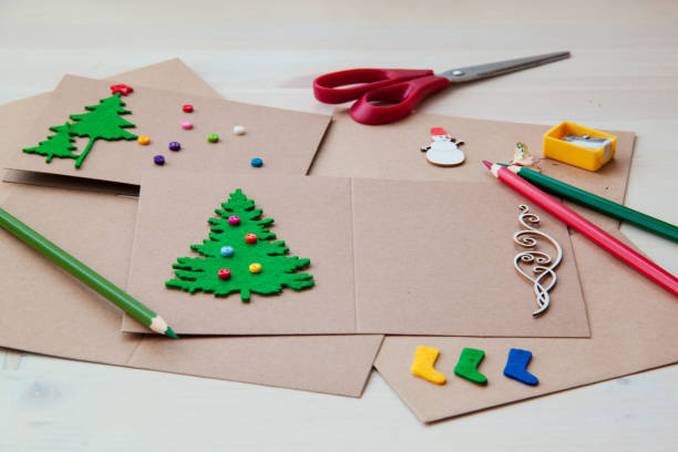 istock Signing Handmade Christmas cards. Felt, scissors, buttons, Christmas-tree, scrapping. Flat lay 879304966
