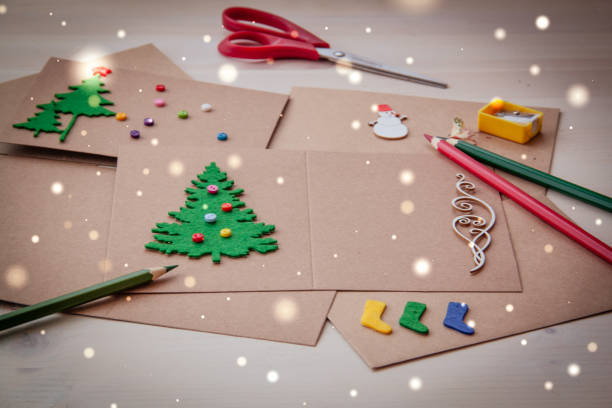 istock Signing Handmade Christmas cards. Felt, scissors, buttons, Christmas-tree, scrapping. Flat lay 879305144