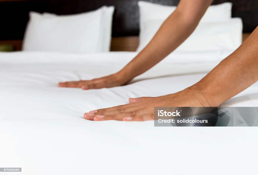 Making Bed Woman making bed. Bed - Furniture Stock Photo