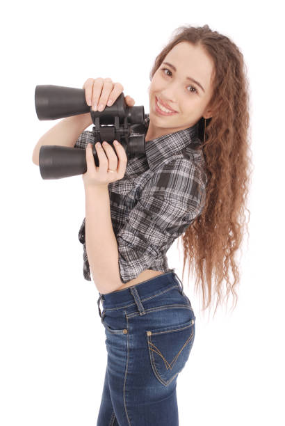istock Attractive smiling young girl with binoculars 879309184