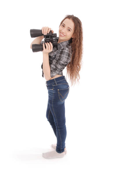 istock Attractive smiling young girl with binoculars 879309294