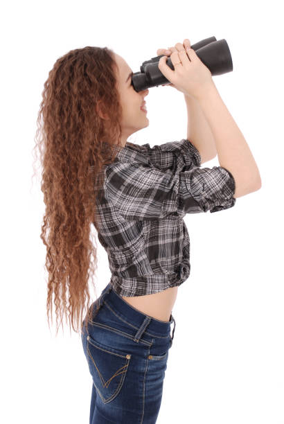 istock Attractive smiling young girl with binoculars 879311888