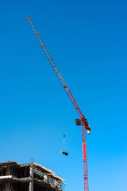 istock Industrial construction crane over modern building site 879311968