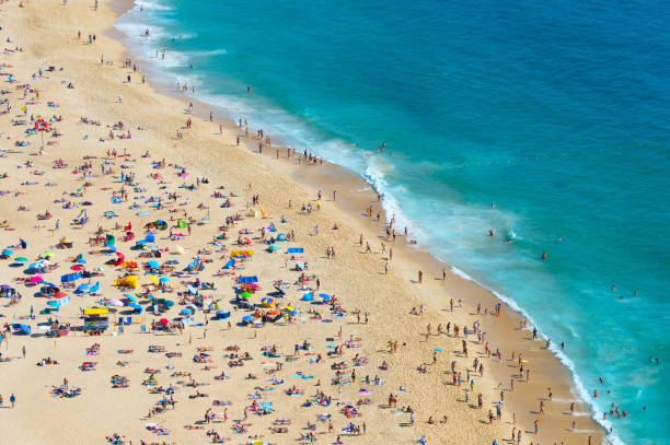 istock Crowded ocean beach. Nazare, Portugal 879318552