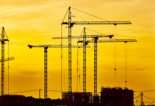 Construction site at dusk evening yellow light, crane