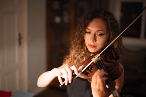 istock Female musician playing violin 879326560