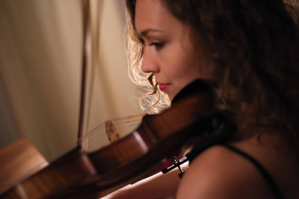 istock Female musician playing violin 879326882