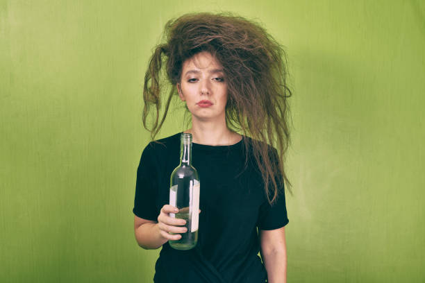 drunk girl with a bottle stock photo