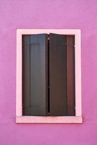 istock Window with green shutter on pink wall. Italy, Venicw, Burano island. 879331884