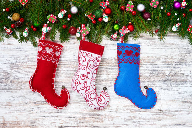 istock Christmas background. Christmas fir tree with Christmas socks on white wooden board background with copy space. 879348564