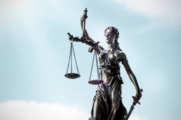 istock Lady justice, themis, statue of justice on sky background 879351108