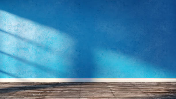 istock Blue plaster wall and wooden floor sunny interior 879357952