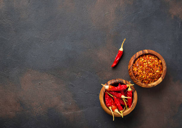 istock Red hot chili peppers on rusty background 879364410