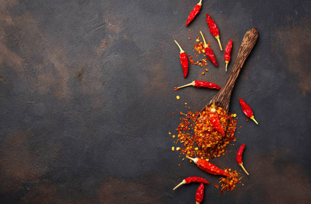 istock Red hot chili peppers on rusty background 879364754
