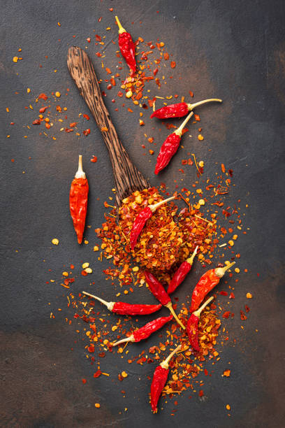 istock Red hot chili peppers on rusty background 879364816