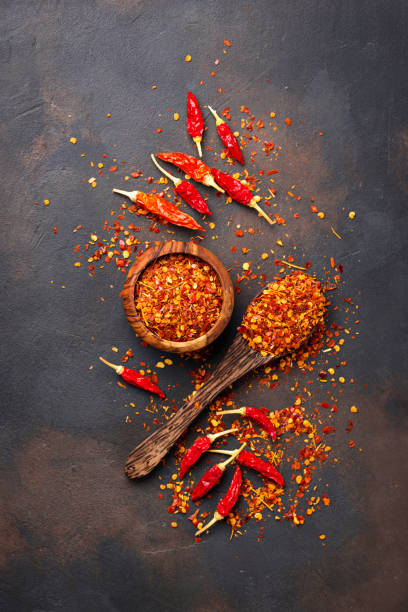 istock Red hot chili peppers on rusty background 879364998
