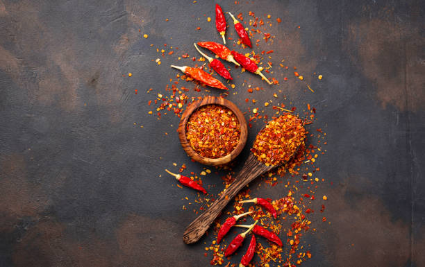 istock Red hot chili peppers on rusty background 879365056