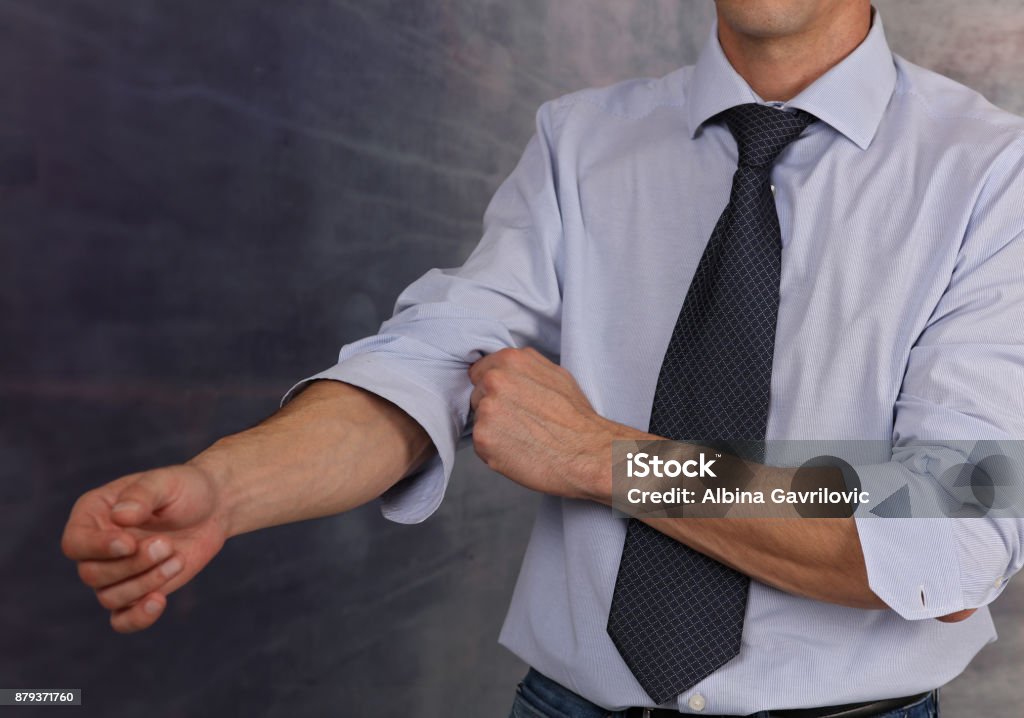 Let's start working. Businessman Rolling Up Sleeves Rolling Stock Photo