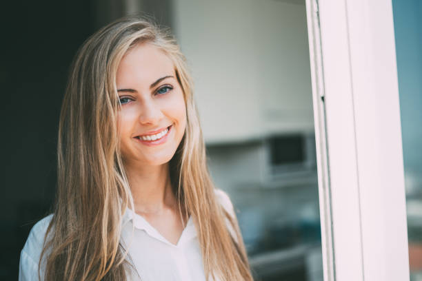 istock Young thoughtful woman looking through the window 879402050