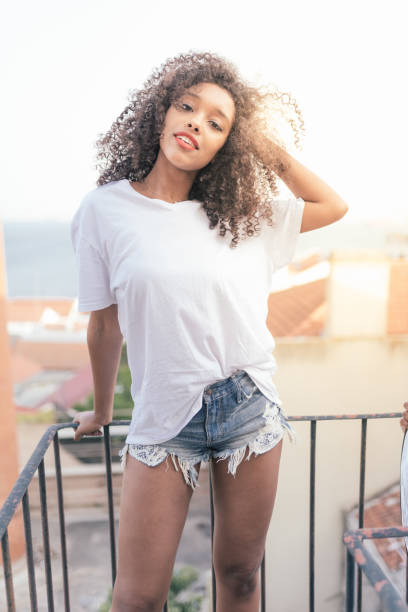 istock Young beautiful black woman on the stairs posing 879402268