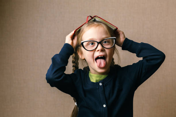 istock little girl with a book over her head 879441128