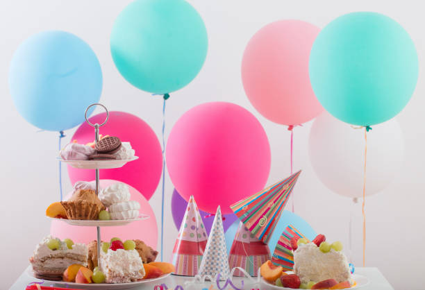 istock Birthday celebration with cake and colorful balloons 879441704