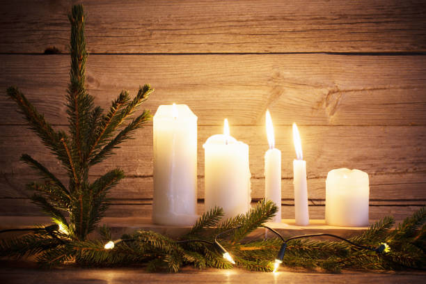 istock Christmas candles on wooden background 879441726