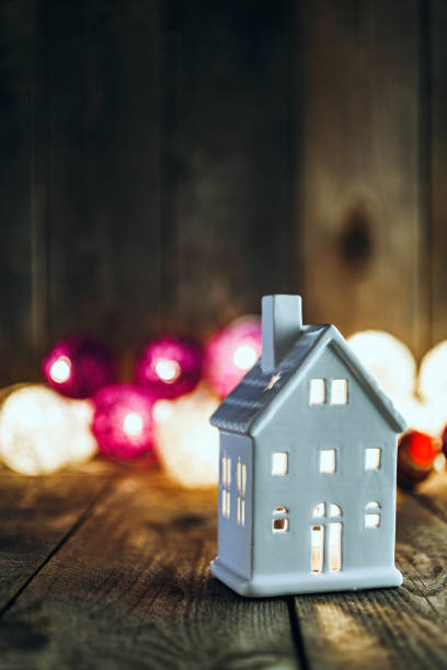 istock White house shaped ceramics candle holder on Christmas background 879442232