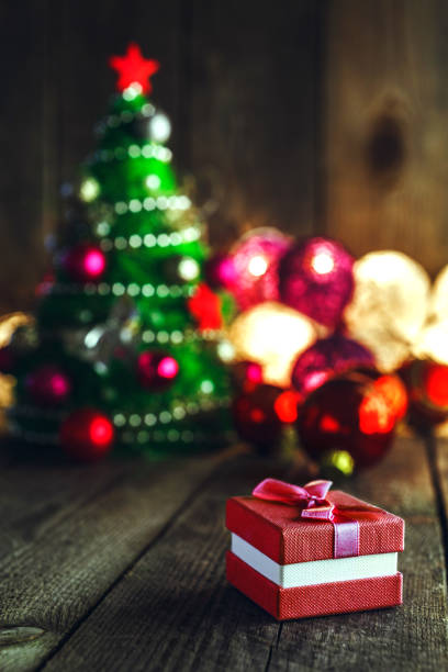 istock Christmas background with decorations and gift box on wooden board 879451882