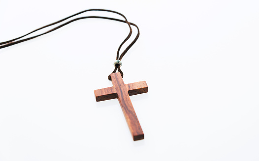 Christian cross necklace on white background