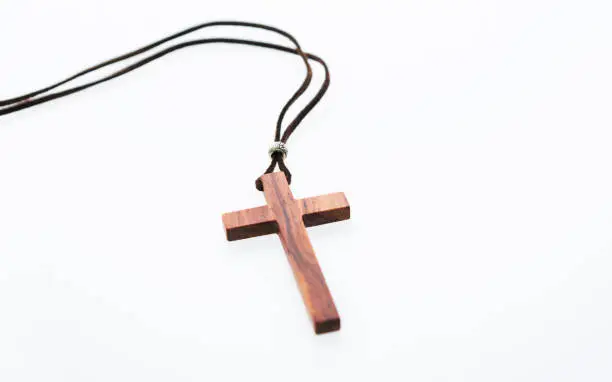 Photo of Christian cross necklace on white background