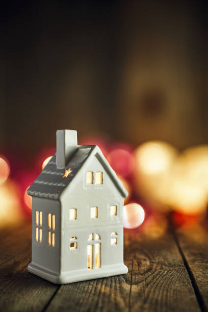 istock White house shaped ceramics candle holder on Christmas background 879454176