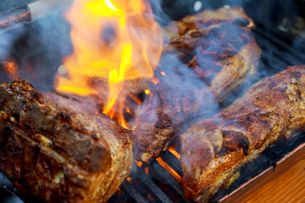 istock grilling baby back pork ribs over flaming grill 879454896