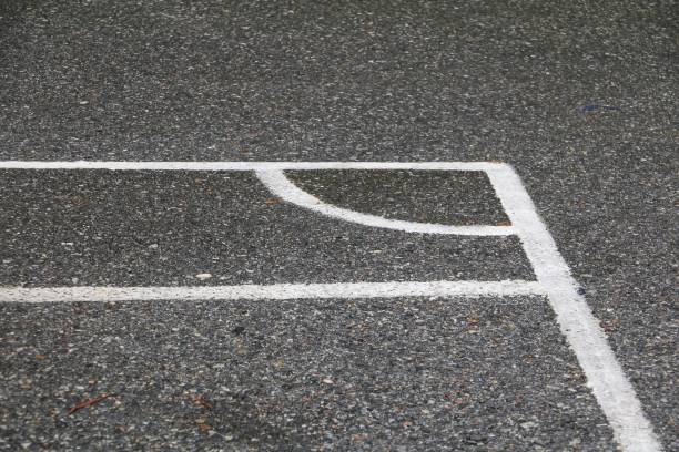 istock Football field corner asphalt wet 879457222