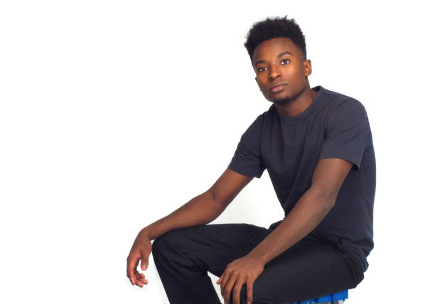 pensive serious person sitting relax wonder thinking young man young man thinking white background studio pensive handsome relax serious three quarter length stock pictures, royalty-free photos & images