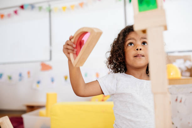 istock Toddler with wooden blocks construction 879460618