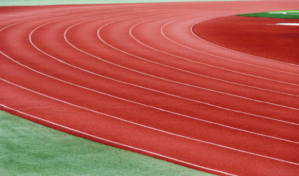 istock Red plastic running track in a playground 879463838