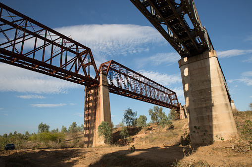 The original heritage listed railway bridge (1899) and the new (1964) high level railway bridges over the Burdekin River east of Charters Towers, Queensland. Looking east, away from the river.