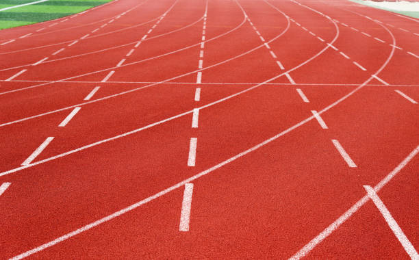 istock Red running track in sport field 879466116