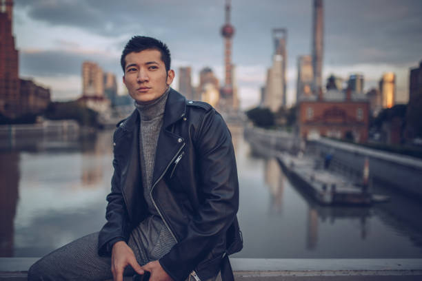 istock Man sitting by the river and holding phone 879481786