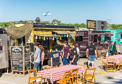 Buenos Aires, Argentina - November 11, 2017: People at a street food market festival on a sunny day