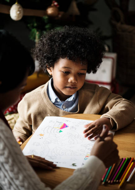 istock African kid enjoying a coloring book 879500296