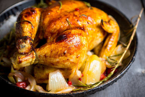 istock Roasted chicken in pan on the rustic wooden background 879507786