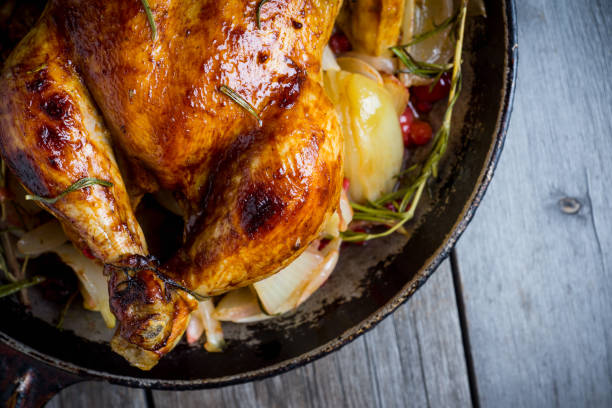 istock Roasted chicken in pan on the rustic wooden background 879507792