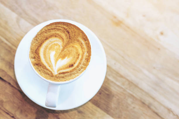 istock Hot art coffee cappuccino in a cup on wooden table background  with copy space 879508040