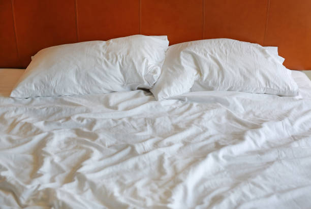 istock Messy and unmade bed in hotel room. 879510810