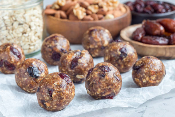 istock Healthy energy balls with cranberries, nuts, dates and rolled oats on parchment, horizontal 879515396