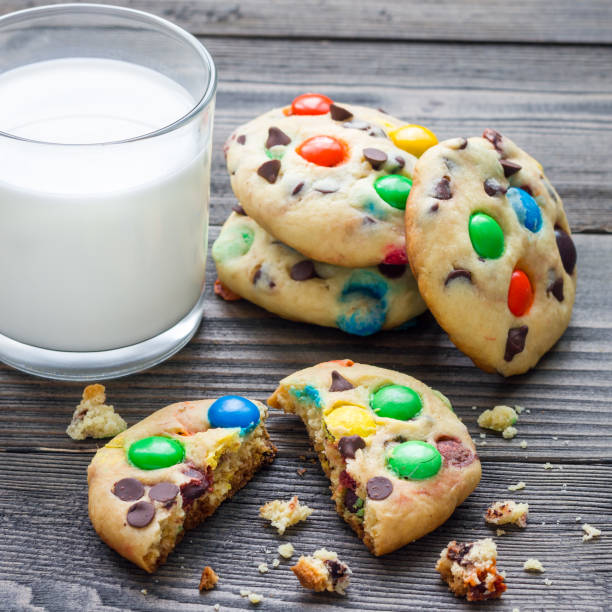 istock Shortbread cookies with multi colored candy and chocolate chips, served with glass of milk, square 879515432