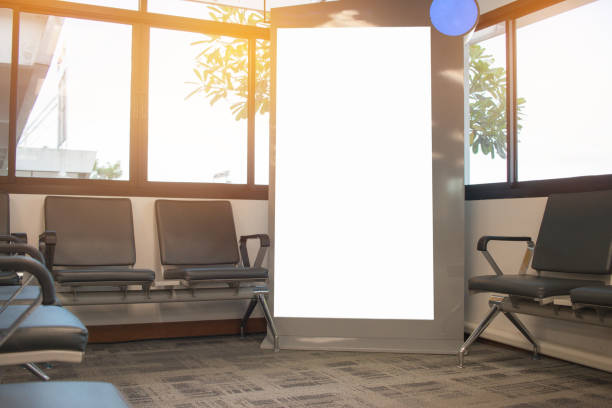 istock Blank billboard advertising panel with chairs for guest passenger in terminal airport, Mock up white, insert for text of customer. Space for texting. your products or promotional. 879521446